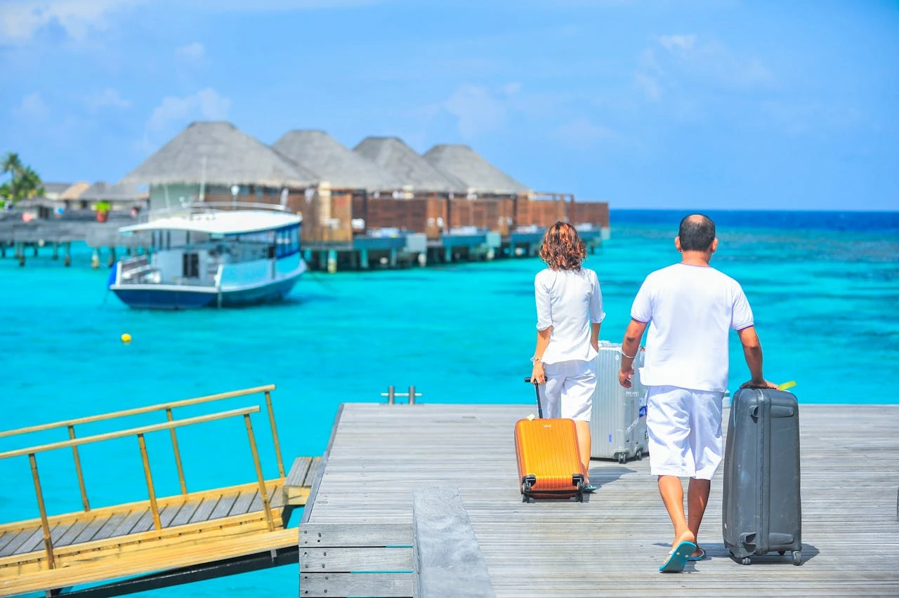 Two people with suitcases